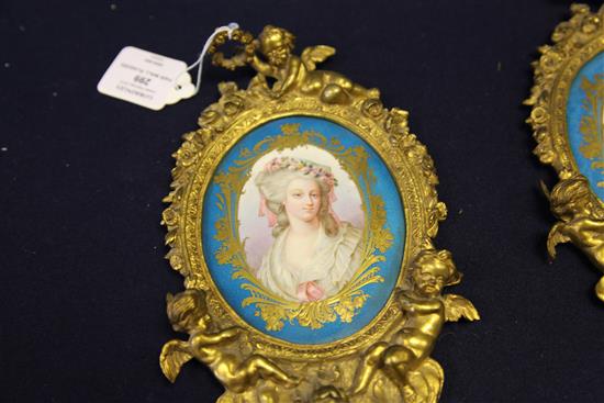 A pair of ormolu mounted Sevres style porcelain wall plaques, late 19th century, 24cm